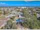 Aerial view of home with in-ground pool and fenced yard in a residential neighborhood at 6961 Dalkeith N Ave, St Petersburg, FL 33709