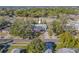 Aerial view of home with fenced backyard, mature trees, and a residential street at 6961 Dalkeith N Ave, St Petersburg, FL 33709