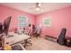 Pink bedroom featuring a white ceiling fan and multiple computer setups on a white desk at 6961 Dalkeith N Ave, St Petersburg, FL 33709