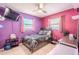 Purple and pink bedroom featuring a ceiling fan and a full sized bed at 6961 Dalkeith N Ave, St Petersburg, FL 33709