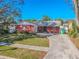 Charming single-story brick home featuring a well-maintained lawn and a concrete driveway at 6961 Dalkeith N Ave, St Petersburg, FL 33709