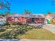 Charming single-story brick home with well-maintained lawn and inviting front entrance at 6961 Dalkeith N Ave, St Petersburg, FL 33709