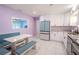 Modern kitchen with white cabinets, stainless steel appliances, and breakfast nook at 6961 Dalkeith N Ave, St Petersburg, FL 33709