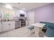 Bright kitchen boasts white cabinets, stainless appliances, and a cozy breakfast nook at 6961 Dalkeith N Ave, St Petersburg, FL 33709