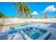 Backyard pool and hot tub featuring blue tiles and outdoor seating for ultimate relaxation at 6961 Dalkeith N Ave, St Petersburg, FL 33709