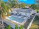 Aerial view of a backyard with a sparkling pool, hot tub, and patio furniture at 6961 Dalkeith N Ave, St Petersburg, FL 33709