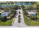 An aerial view of a community with luxurious homes, manicured landscaping, and access to a scenic golf course and waterways at 7185 N Serenoa Dr, Sarasota, FL 34241