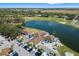 Aerial view featuring clubhouse overlooking lake and golf course surrounded by lush landscape at 7185 N Serenoa Dr, Sarasota, FL 34241