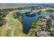 Expansive aerial view of the golf course and lakes behind residential homes at 7185 N Serenoa Dr, Sarasota, FL 34241
