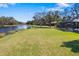 Spacious backyard with lush green lawn and scenic lake view, perfect for outdoor activities at 7185 N Serenoa Dr, Sarasota, FL 34241