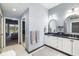 Beautiful bathroom with double sinks, granite countertops, decorative mirrors, and access to the bedroom and pool area at 7185 N Serenoa Dr, Sarasota, FL 34241