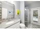 Bright bathroom with a glass shower, granite counters and access to the outdoor pool at 7185 N Serenoa Dr, Sarasota, FL 34241