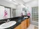 Elegant bathroom featuring double sinks, granite countertops, and natural light at 7185 N Serenoa Dr, Sarasota, FL 34241
