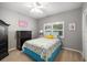 Bright bedroom featuring coastal decor, a large window, and closet at 7185 N Serenoa Dr, Sarasota, FL 34241