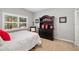 Cozy bedroom with a comfortable bed, large window and a dark wood dresser at 7185 N Serenoa Dr, Sarasota, FL 34241