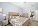 Comfortable main bedroom with calming blue walls, plush carpeting, and ample natural light at 7185 N Serenoa Dr, Sarasota, FL 34241