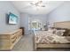 Comfortable bedroom featuring a ceiling fan, TV, and sliding door access to the outdoor pool area at 7185 N Serenoa Dr, Sarasota, FL 34241