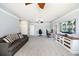 Spacious bonus room with a seating area, desks, built-ins, and a large TV, perfect for entertainment and relaxation at 7185 N Serenoa Dr, Sarasota, FL 34241