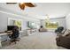 Large bonus room with built-ins, a TV, and a large picture window providing natural light and scenic views at 7185 N Serenoa Dr, Sarasota, FL 34241