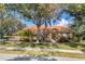 Charming single-story home with lush landscaping, a terracotta roof, and a welcoming facade at 7185 N Serenoa Dr, Sarasota, FL 34241