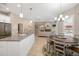 Open-concept kitchen featuring an island, stainless steel appliances, and seamless flow to the living area at 7185 N Serenoa Dr, Sarasota, FL 34241