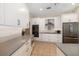 Well-lit kitchen boasts white cabinets, stainless steel appliances, and stone countertops for a modern look at 7185 N Serenoa Dr, Sarasota, FL 34241