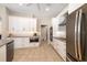 Updated kitchen featuring stainless steel appliances, modern lighting, and abundant storage space at 7185 N Serenoa Dr, Sarasota, FL 34241