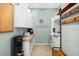 Well-organized laundry room with modern appliances, ample storage, and a folding counter at 7185 N Serenoa Dr, Sarasota, FL 34241