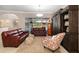 Spacious living room featuring tile floors, leather furniture and sliding glass doors to the lanai at 7185 N Serenoa Dr, Sarasota, FL 34241