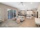Inviting living room with a large sliding door, tiled floor, and open layout to the kitchen and dining areas at 7185 N Serenoa Dr, Sarasota, FL 34241