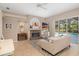 Relaxing living room showcasing a fireplace, comfortable seating, and access to a screened-in porch overlooking the pool at 7185 N Serenoa Dr, Sarasota, FL 34241