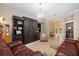 Bright living room with comfortable seating, a vintage gas pump, and large windows at 7185 N Serenoa Dr, Sarasota, FL 34241