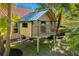 Charming backyard playhouse amidst lush, tropical landscaping at 7185 N Serenoa Dr, Sarasota, FL 34241