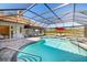 Screened-in pool and spa offer a relaxing retreat with lounge chairs and outdoor entertaining space at 7185 N Serenoa Dr, Sarasota, FL 34241
