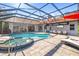 Private, screened-in pool and spa with brick pavers and outdoor entertaining area at 7185 N Serenoa Dr, Sarasota, FL 34241