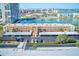 Aerial view of a condo complex with covered parking, mature landscaping, and waterfront access with boat docks at 7420 Bay Island S Dr # 281, South Pasadena, FL 33707