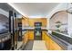 Well-lit kitchen with oak cabinets, black appliances, and granite countertops, perfect for any home chef at 7420 Bay Island S Dr # 281, South Pasadena, FL 33707
