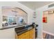 Eat-in kitchen featuring a breakfast bar with granite countertops, views to the living area, and stainless appliances at 7420 Bay Island S Dr # 281, South Pasadena, FL 33707