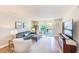 Bright living room featuring a sliding glass door to a balcony with water views and contemporary decor at 7420 Bay Island S Dr # 281, South Pasadena, FL 33707