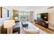 Relaxing living room with cozy seating, wood-look floors, and a large window to the outdoor balcony at 7420 Bay Island S Dr # 281, South Pasadena, FL 33707