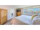 Cozy bedroom with waterfront view, complemented by a neutral palette and wood-look flooring at 7420 Bay Island S Dr # 281, South Pasadena, FL 33707