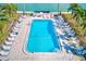 Aerial view of a rectangular pool surrounded by lounge chairs and lush landscaping at 7420 Bay Island S Dr # 281, South Pasadena, FL 33707