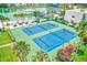 Aerial view of tennis courts and a pool area surrounded by landscaping at 7420 Bay Island S Dr # 281, South Pasadena, FL 33707