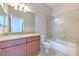 Tiled bathroom with vanity, toilet, bathtub and shower at 7570 Tamarind Ave, Tampa, FL 33625