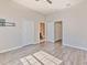 Spacious bedroom with wood-look flooring, closet, and ensuite bathroom at 7570 Tamarind Ave, Tampa, FL 33625