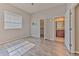 Well-lit bedroom with wood floors, a window, and closet and bathroom access at 7570 Tamarind Ave, Tampa, FL 33625