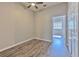 A cozy bedroom features neutral walls, modern ceiling fan and closet for ample storage at 7570 Tamarind Ave, Tampa, FL 33625