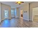 Spacious bedroom with wood-look flooring, closet, bathroom and outdoor access at 7570 Tamarind Ave, Tampa, FL 33625