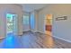 Bright bedroom with wood-look flooring and access to a bathroom and balcony at 7570 Tamarind Ave, Tampa, FL 33625