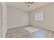 Bright bedroom with wood-look flooring and a window for natural light at 7570 Tamarind Ave, Tampa, FL 33625